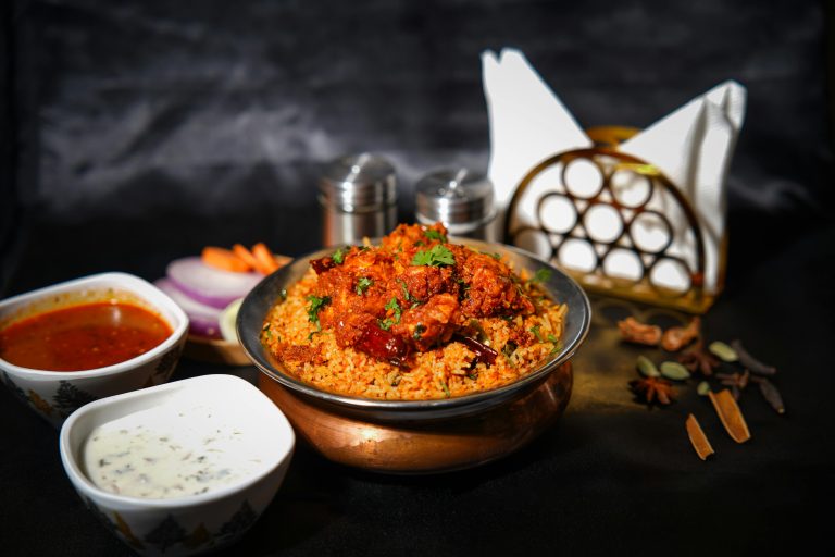 Mouth-watering chicken biryani with spices, sauces, and garnishes, perfect for food lovers.